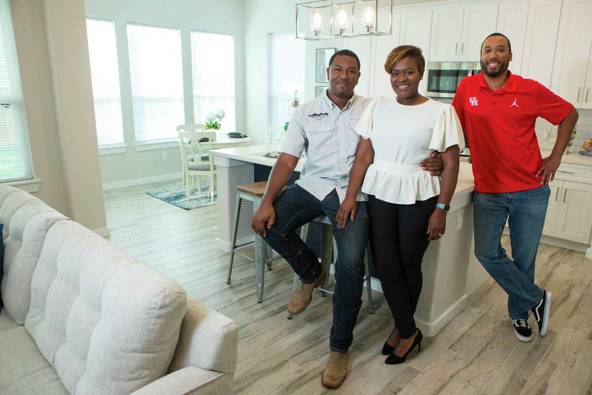 Kevan and Ayesha Shelton, left, and Junious Williams pose for a portrait in one of the homes they have built in the Grand Park Square development Thursday, Nov. 12, 2020 in Houston. Shelton is developing homes in the Greater South Union area. Grand Park Square is meant to to inspire a new sense of community and drive to preserve and maintain the culture in the area as gentrification threatens other historic, underserved neighborhoods.