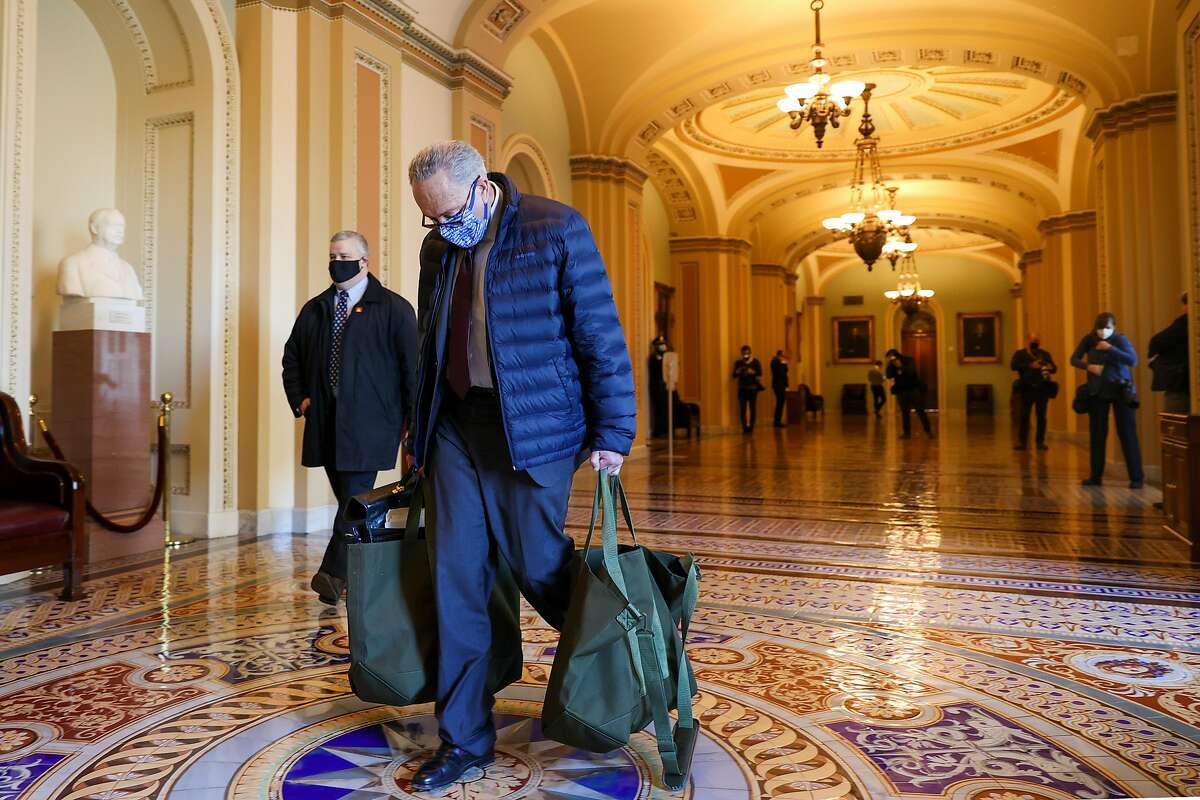 Senate Minority Leader Chuck Schumer, D-N.Y., arrives on Capitol Hill on Tuesday. The House has passed a larger coronavirus relief bill but it appears stalled in the Senate.