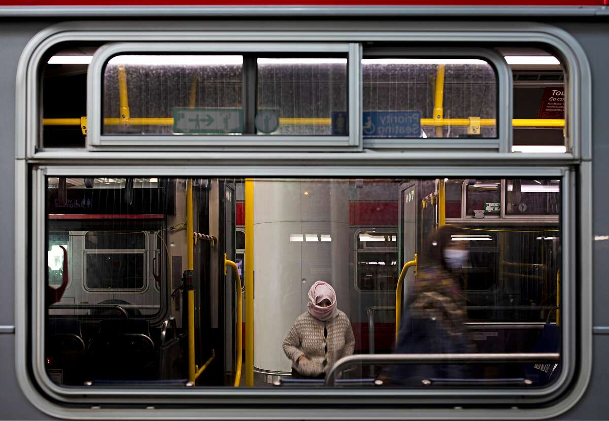 The only two passengers board a Muni bus that departs from Salesforce Transit Center, Thursday, Dec. 24, 2020, in San Francisco, Calif. The coronavirus pandemic led to a decline in public transportation ridership.