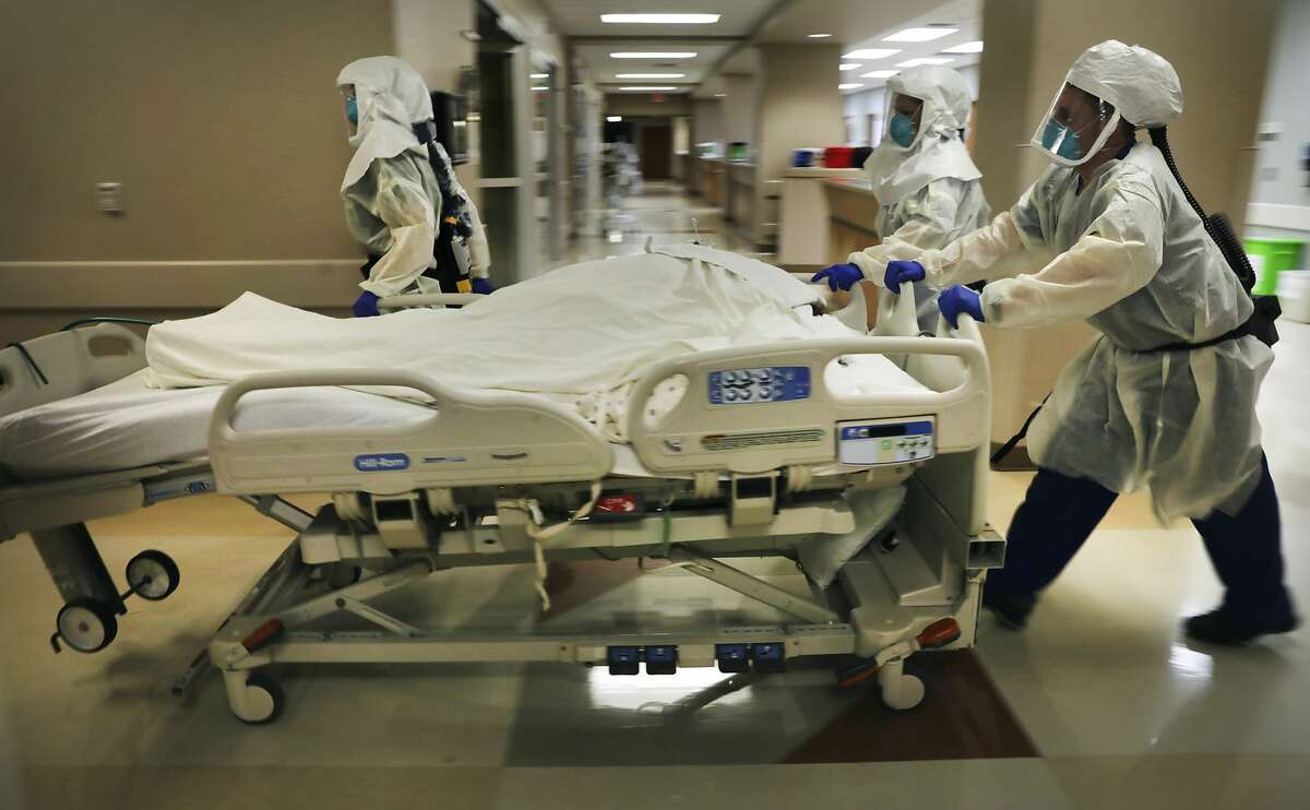 Dr. Tamara Simpson and two nurses rush a covid patient to the Northeast Baptist Hospital Covid Unit, on Friday, April 24, 2020.