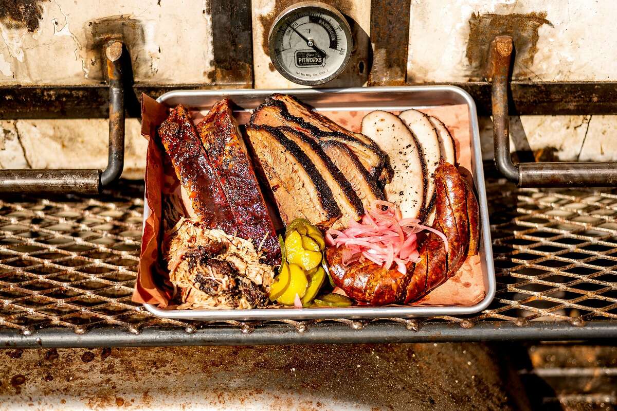A tray of meat rests on a smoker at Horn Barbecue in Oakland.