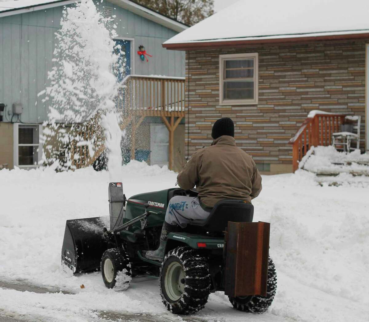 Northern Michigan residents brought out their snow blowers, salt and shovels Wednesday morning following a winter storm which hit the region overnight. (Kyle Kotecki/News Advocate)
