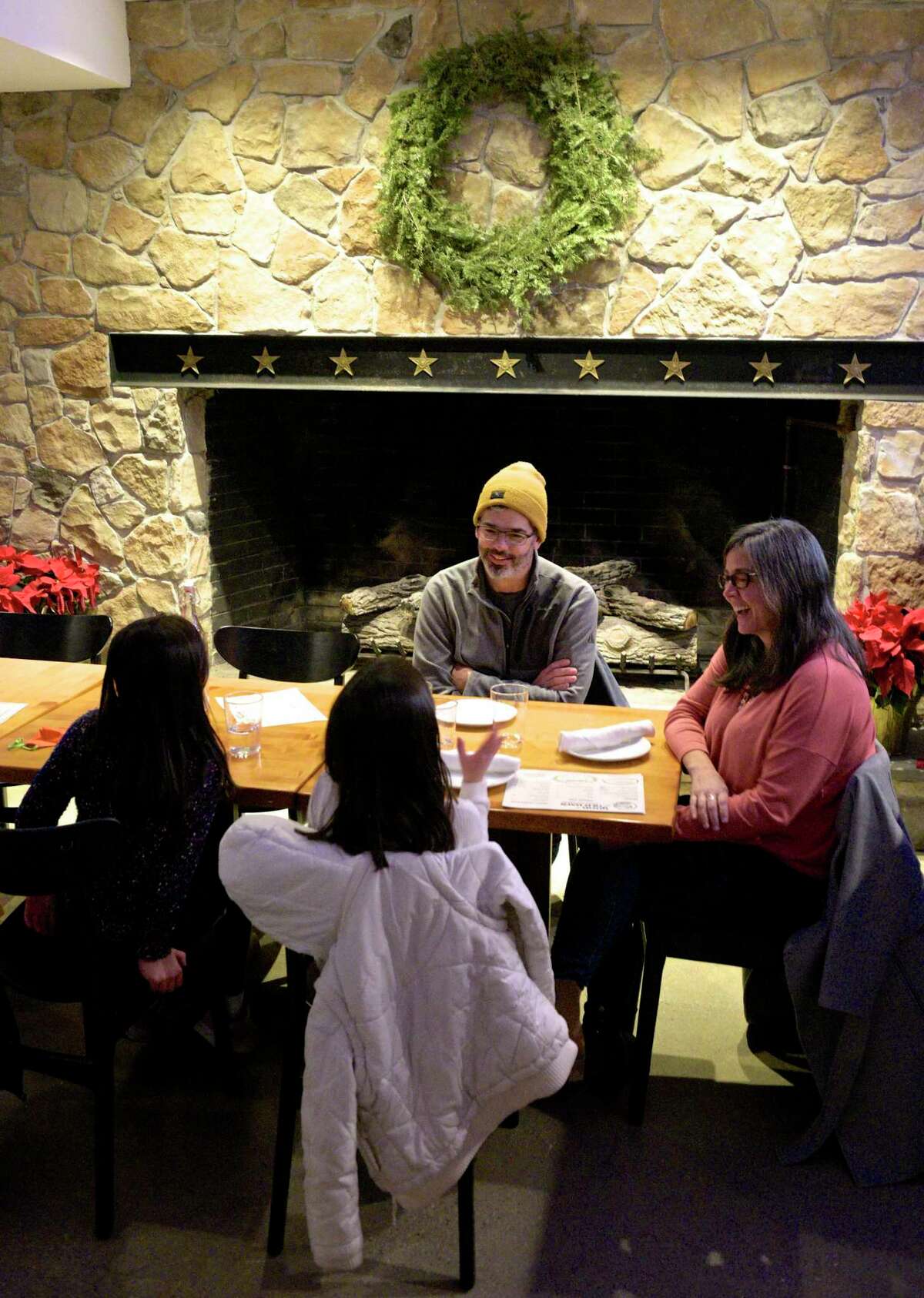 The Kakos family of Danbury, Holland, 6, left, Maryn, 8, Gary and Alaina are at Good Old Days Pizzeria and Cocktail Den, in the lower level of Marygold's on Main, on its opening night, Wednesday, December 30, 2020, in Newtown. Conn. they said they follow Matt, pizza guy Matteo Stanz, on Instagram and go wherever he's cooking.