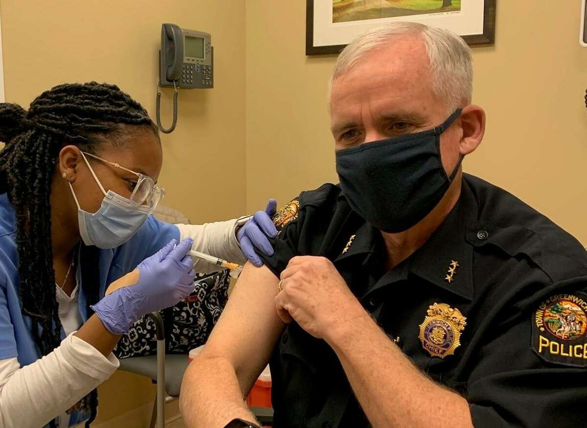 Greenwich Police Chief James Heavey receives a vaccination for the coronavirus.