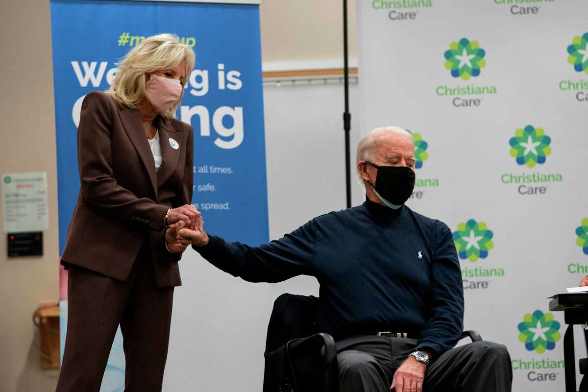 Jill Biden holds the hand of President-elect Joe Biden after he recieved a COVID-19 vaccination on Dec. 21. Jill Biden might not be a medical doctor, but she has earned her title.