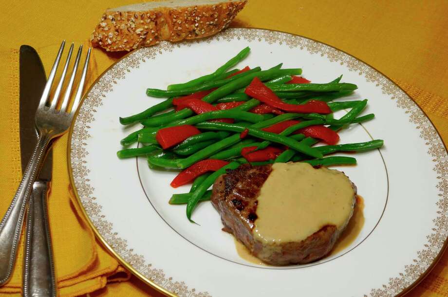 Beef tenderloin in cognac sauce with French green beans. (Linda Gassenheimer/TNS)