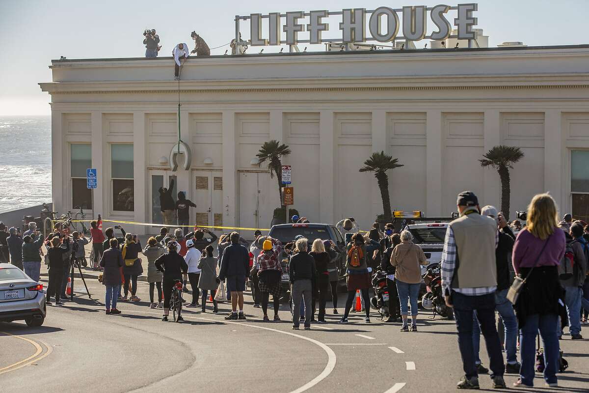 The Cliff House sign is taken down, Thursday, Dec. 31, 2020, in San Francisco, Calif. The 157-year-old Cliff House closed permanently.