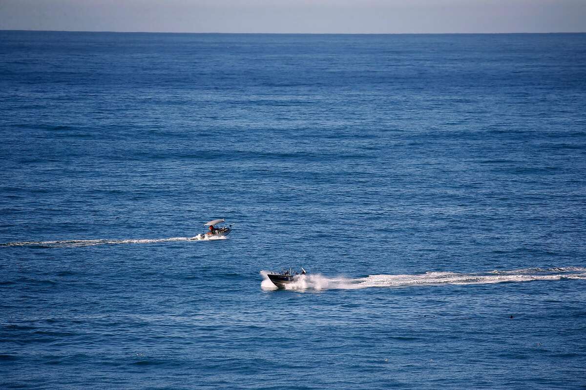 Boats pass each other near Bodega Head in Bodega Bay, Calif. on Wednesday, Dec. 23, 2020. Bodega Head is a popular spot for whale watching.