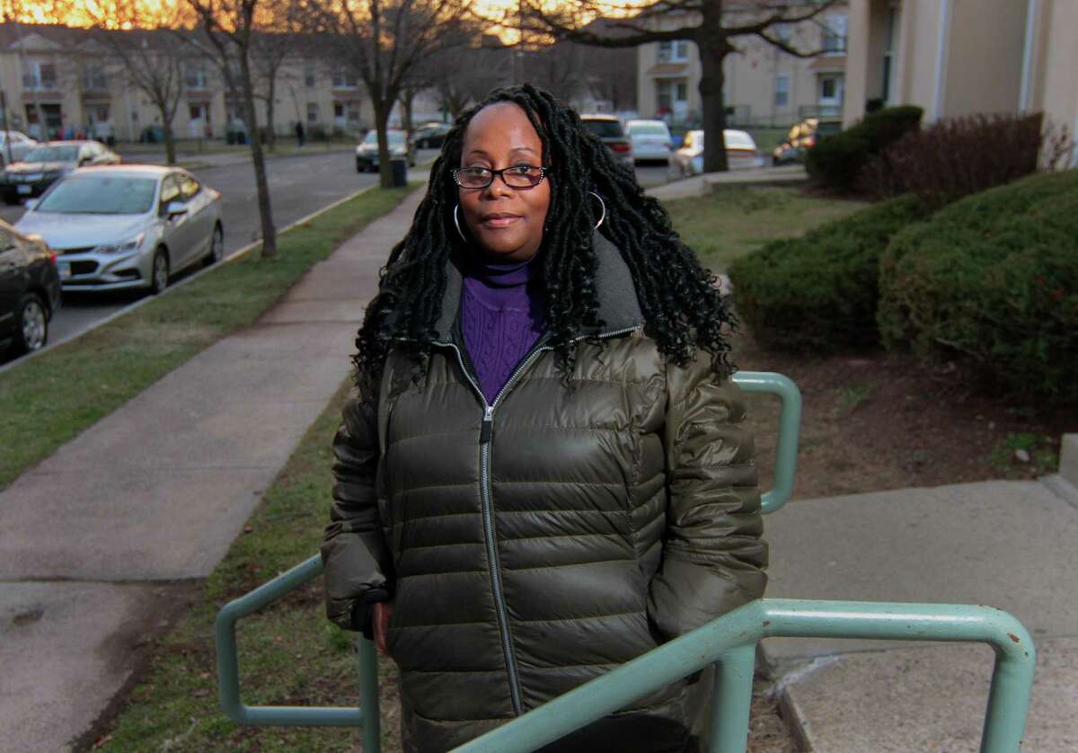 Sylvia Cooper poses outside of her apartment in New Haven Dec. 30, 2020. Cooper works on a state contract interviewing people in need during the pandemic to help connect them with resources. But after losing income because in-person work couldn't happen anymore, she is welcoming the stimulus money to help her make ends meet.