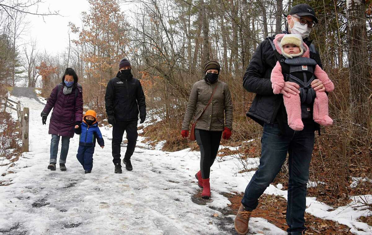 From left, Rachel Rupright of Albany, her son Seungjae Monticello, 3, and husband Alex Monticello take a hike with their friends Stefanie Morton of Delmar, her husband Erik Morton and daughter Sal, 7 mos., at Five Rivers Environmental Education Center on Friday, Jan. 1, 2021 in Delmar, N.Y. (Lori Van Buren/Times Union)