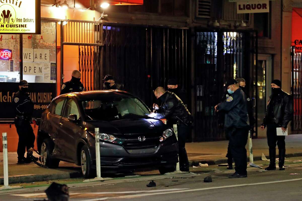 San Francisco police investigate the scene of a fatal hit-and-run on Second Street just north of Mission Street on Thursday. Parolee Troy Ramon McAlister, 45, has been accused of killing two pedestrians.
