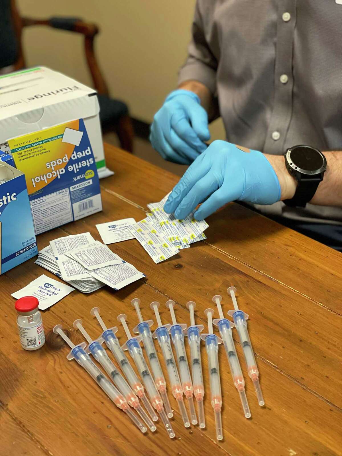 A pharmacist with Brookshire Brothers prepares doses of COVID-19 vaccine to be administered to care workers and vulnerable people based on Texas' priority plan.
