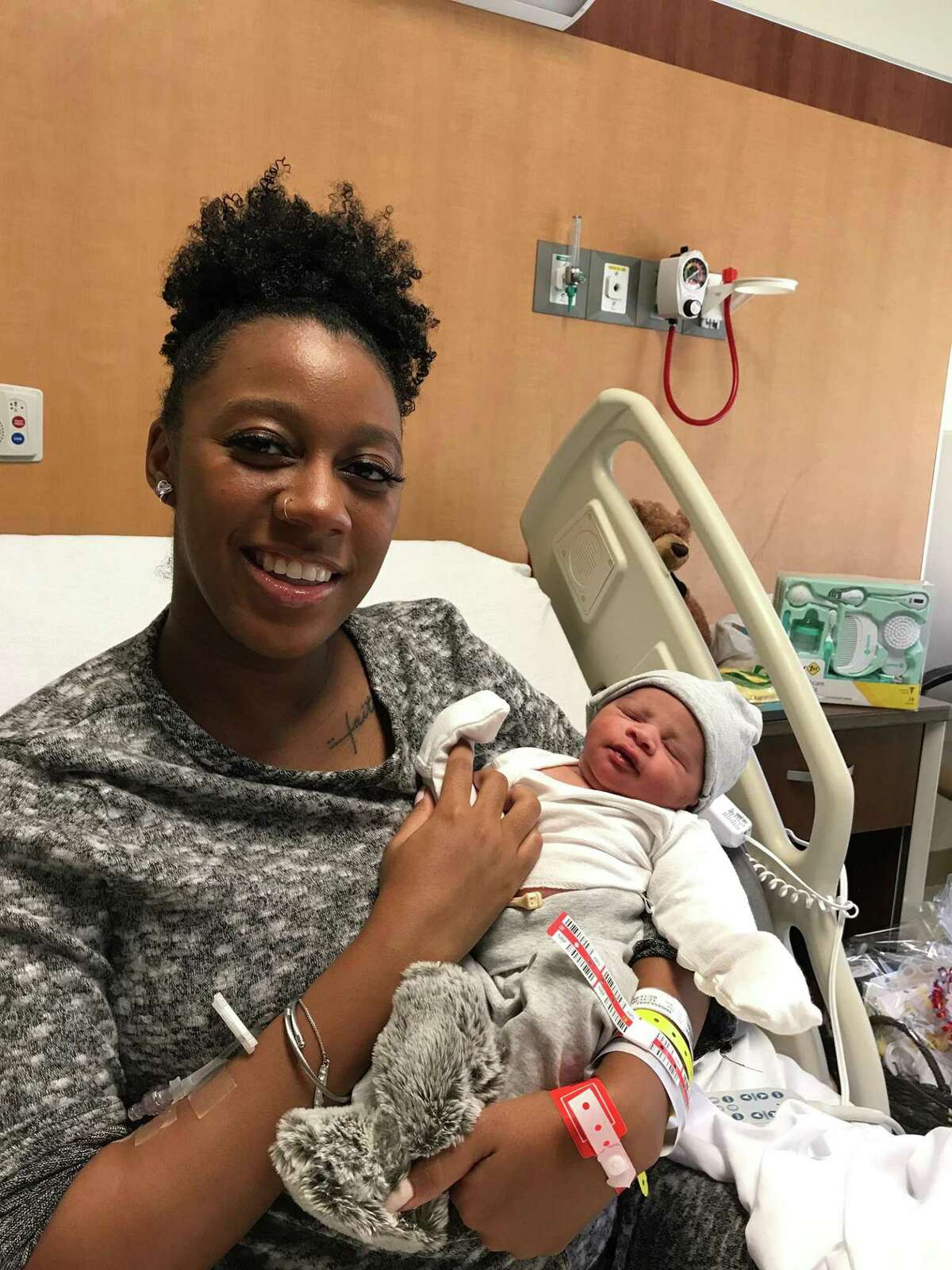 Cheryse Williams holds her newborn Khario Deyvan Moore at North Central Baptist Hospital. The baby was born at 12:53 a.m.