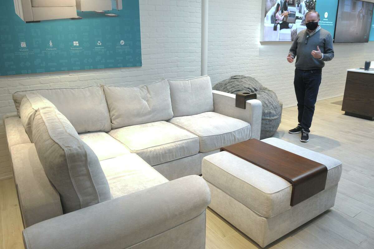 Sales associate Sean Baker shows one of the Sactional sets available at the Lovesac showroom at 68 Post Road E., in downtown Westport, Conn., on Dec. 23, 2020.