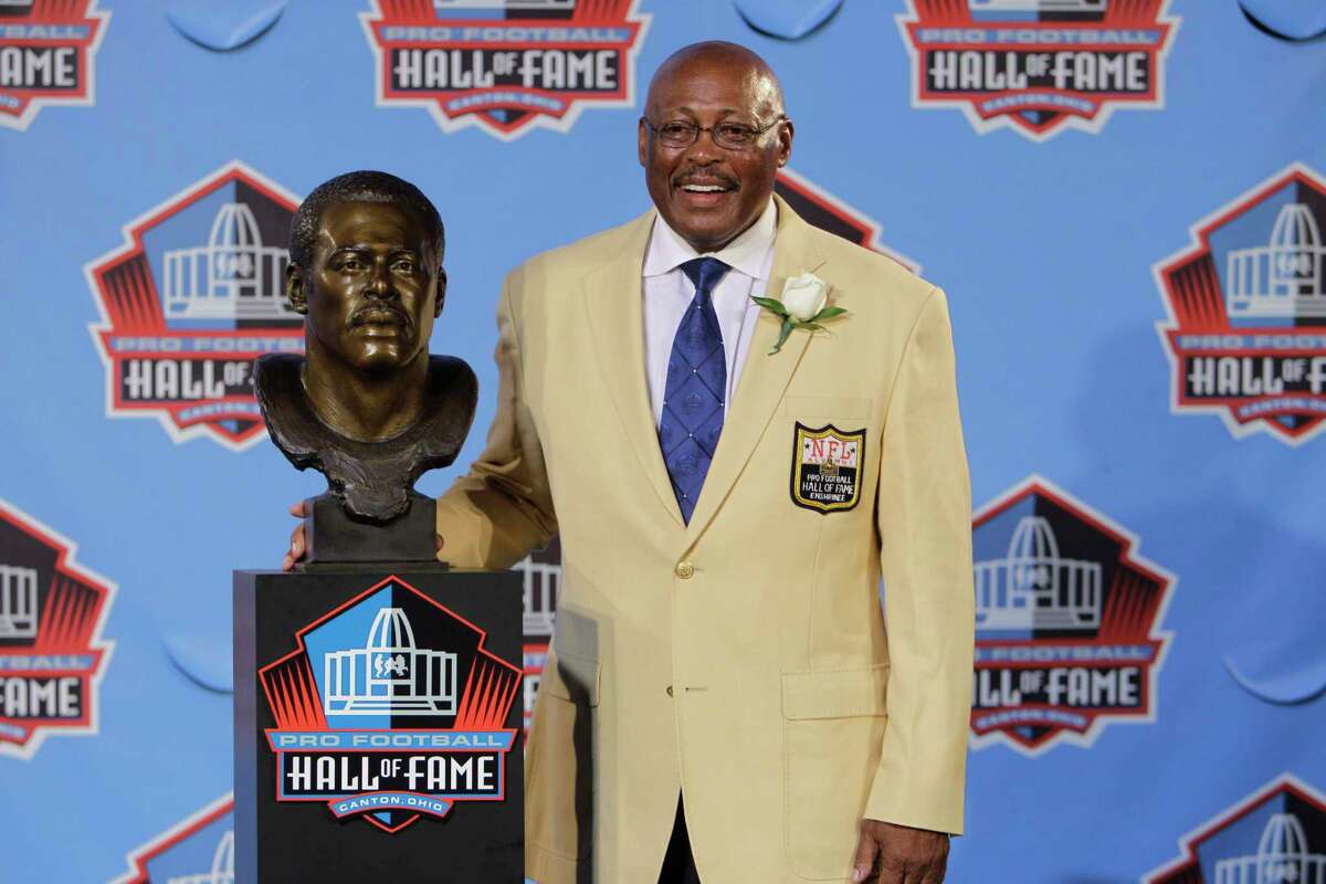 Floyd Little poses with his bust after enshrinement in the Pro Football Hall of Fame in Canton, Ohio Saturday, Aug. 7, 2010. (AP Photo/Mark Duncan)