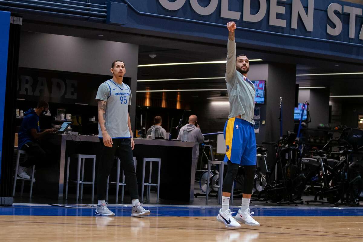 Warriors guard Mychal Mulder watches his shot on Saturday, Jan. 2, 2021, on the practice court at Chase Center in San Francisco, Calif., as teammate Juan Toscano-Anderson, left, looks on.