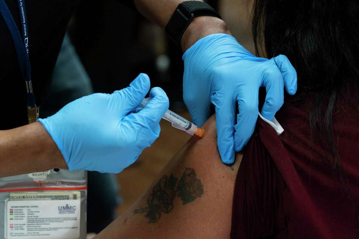 A healthcare worker receives the Moderna COVID-19 vaccine at the United Memorial Medical Center on December 21, 2020, in Houston. (Go Nakamura/Getty Images/TNS)