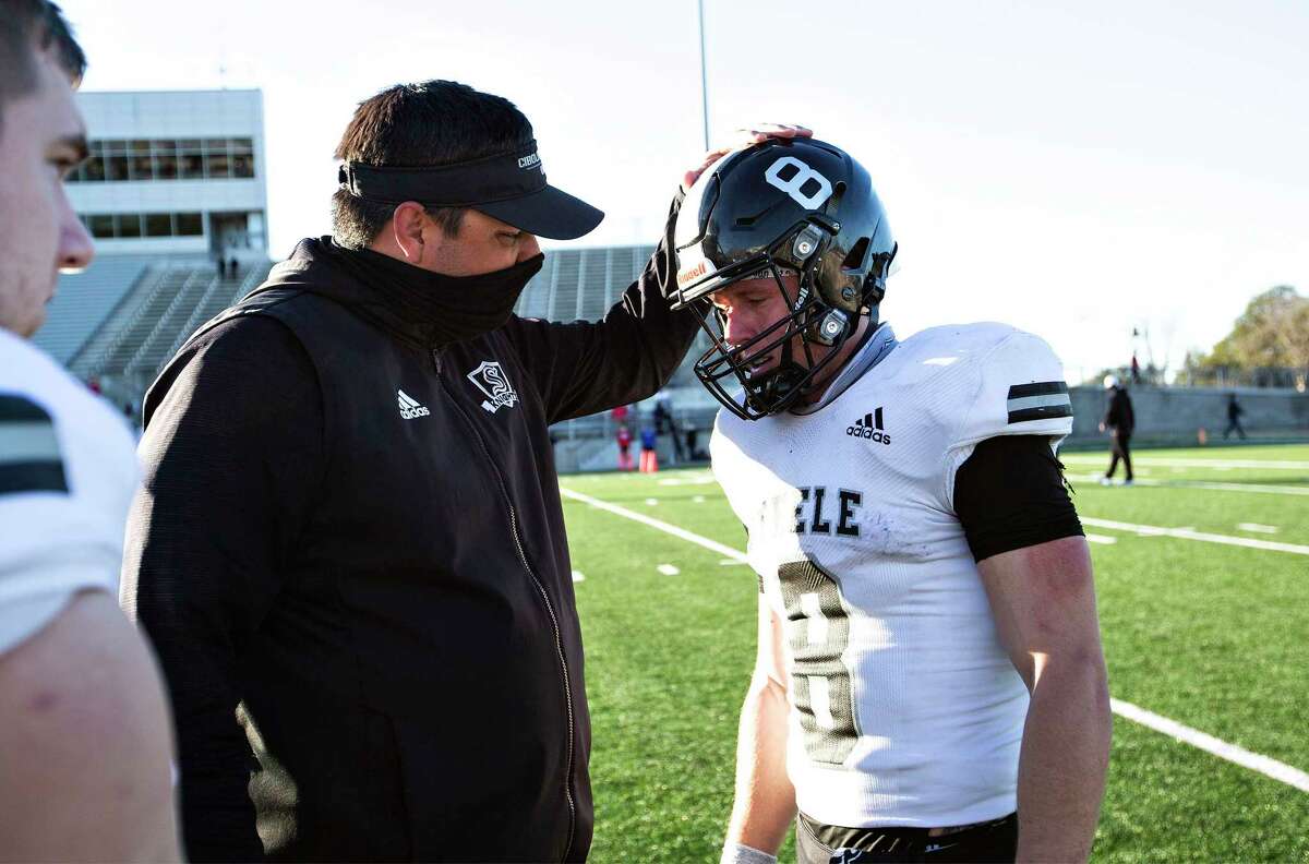 Coach Steve Driffill talks to Steele player Wyatt Begeal (8) after their loss to Westlake at their 6A Division I state quarterfinals UIL football game at the Kelly Reeves Athletic Complex on January 2, 2021 in Round Rock, Texas.