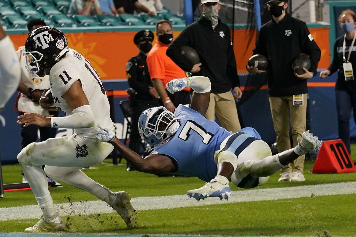Texas A&M quarterback Kellen Mond rushes for the tying touchdown in the fourth quarter ahead of North Carolina linebacker Eugene Asante in Saturday’s Orange Bowl.