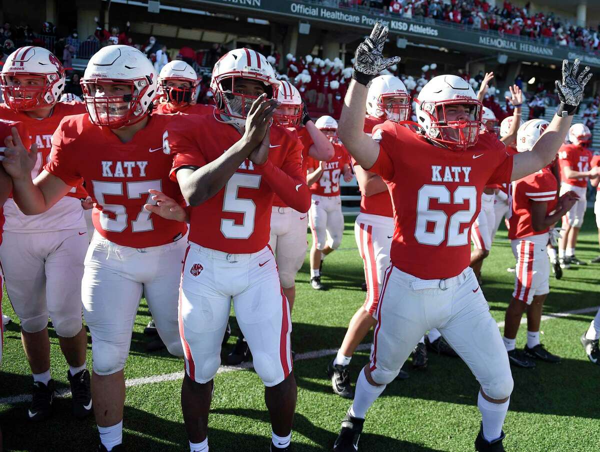 Katy’s Cole Rogers (57), JaKorien Haynes (5) and Skylar Wiggins (62) celebrate the team’s win over Clear Falls in the 6A Division II Region III Final high school football playoff game last weekend. The Tigers play in the state semifinals at 2 p.m. Saturday in Waco.
