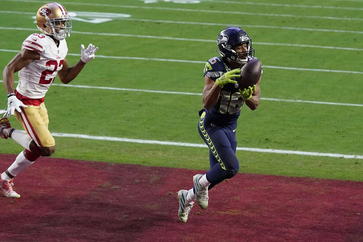 Seattle Seahawks wide receiver Tyler Lockett (16) pulls in a touchdown as San Francisco 49ers cornerback Ahkello Witherspoon (23) defends during the second half of an NFL football game, Sunday, Jan. 3, 2021, in Glendale, Ariz. (AP Photo/Ross D. Franklin)