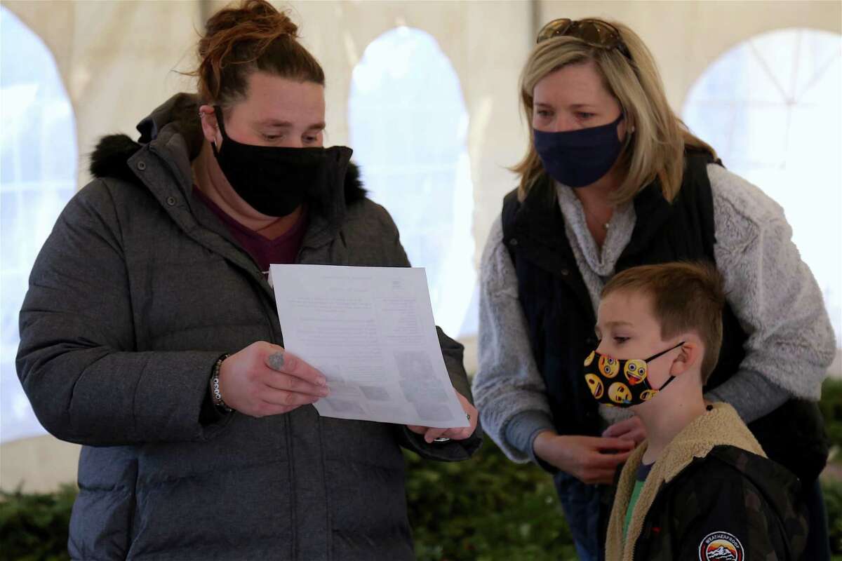 Jennifer Bradshaw, early childhood education coordinator, explains details to Laura Lynch of Wilton and her son Gavin, 6, at the Wreaths for Wildlife at the Woodcock Nature Center on Tuesday, Dec. 29, 2020.