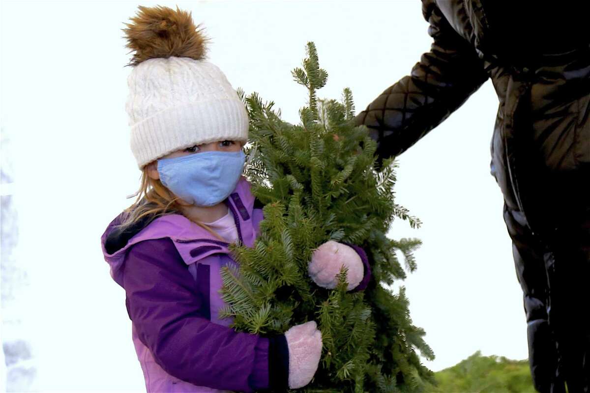 Mac Duff, 6, of Ridgefield totes her wreath.