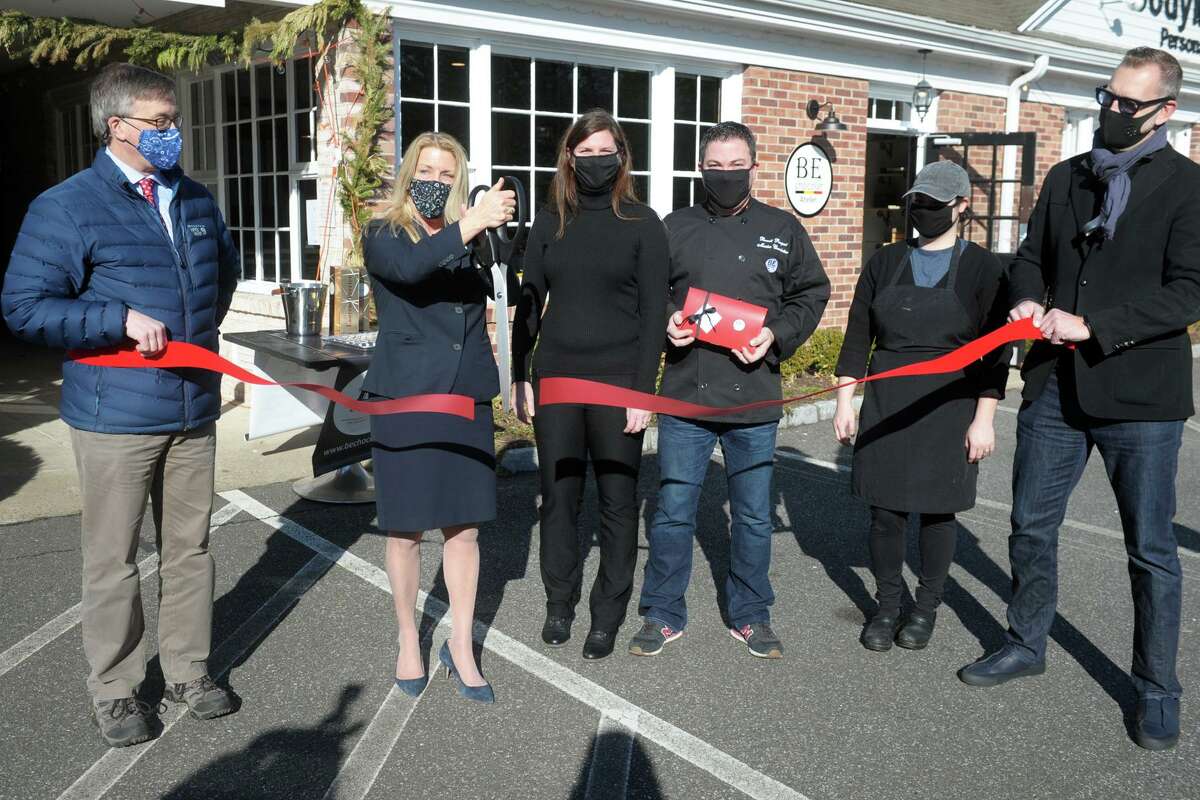 First Selectwoman Brenda Kupchick joins BE Chocolat owners Sylvie Fortin and Benoit Racquet and others for a ribbon cutting in front of the new store and workshop in Fairfield, Conn. Jan. 4, 2021. “We’re excited to present our new atelier and retail shop to the Fairfield County community,” said Benoit Racquet, a Belgian master chocolatier and one of the owners. “The response to our cottage kitchen business was tremendous, leading us to make this move to brick and mortar. It is our passion to create premium Belgium chocolate in small batches, and we’re thrilled to be the first business opening in 2021 in Fairfield.”