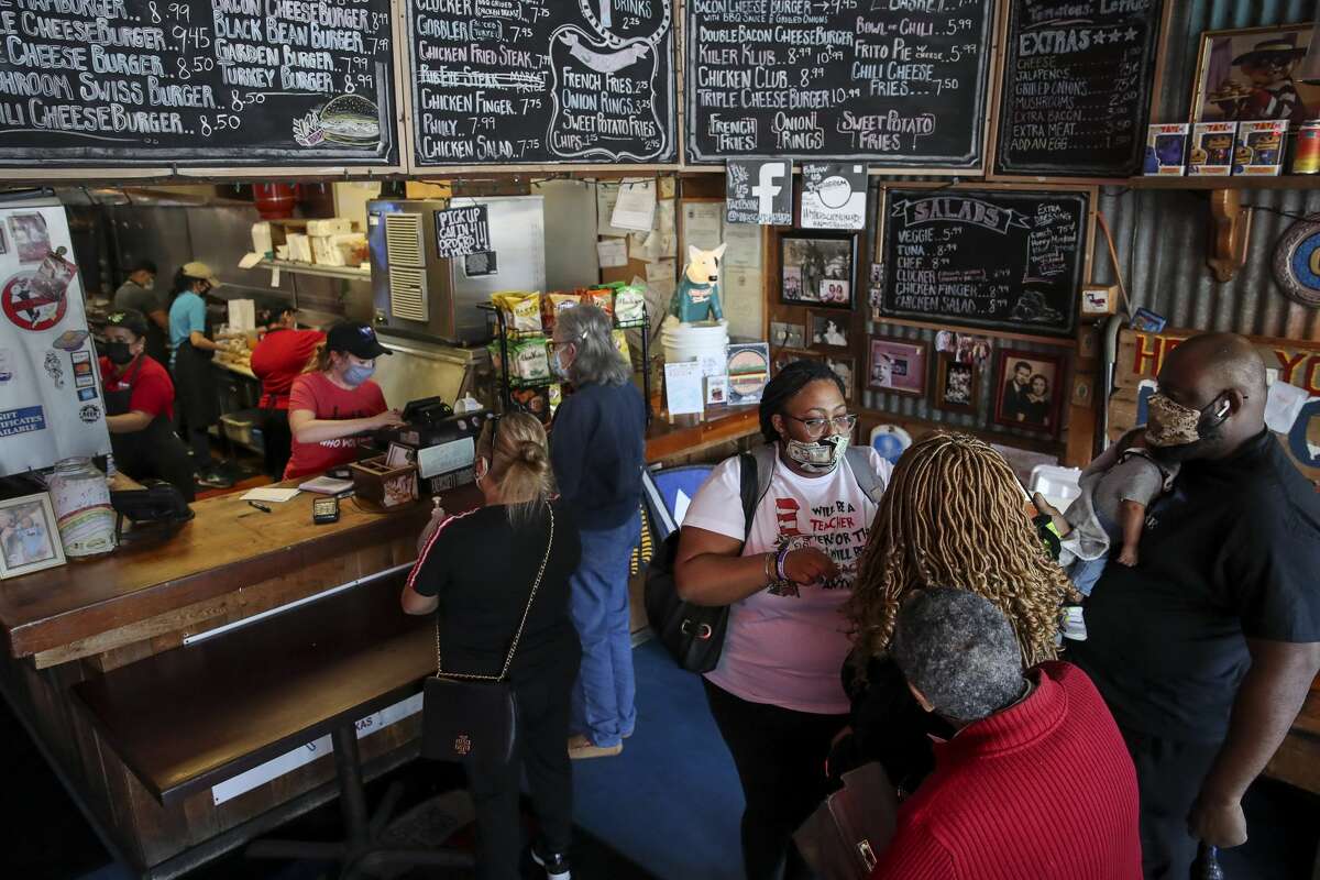 Ashley Morgan, right from center, waits to order food with her mother Dona Morgan, her grandmother Helen Brown, her son Ar'Marrion Jones, 8 weeks old, and her fiancÃ© Rollie Jones on Monday, Jan. 4, 2021, at Miller's Cafe in Houston.