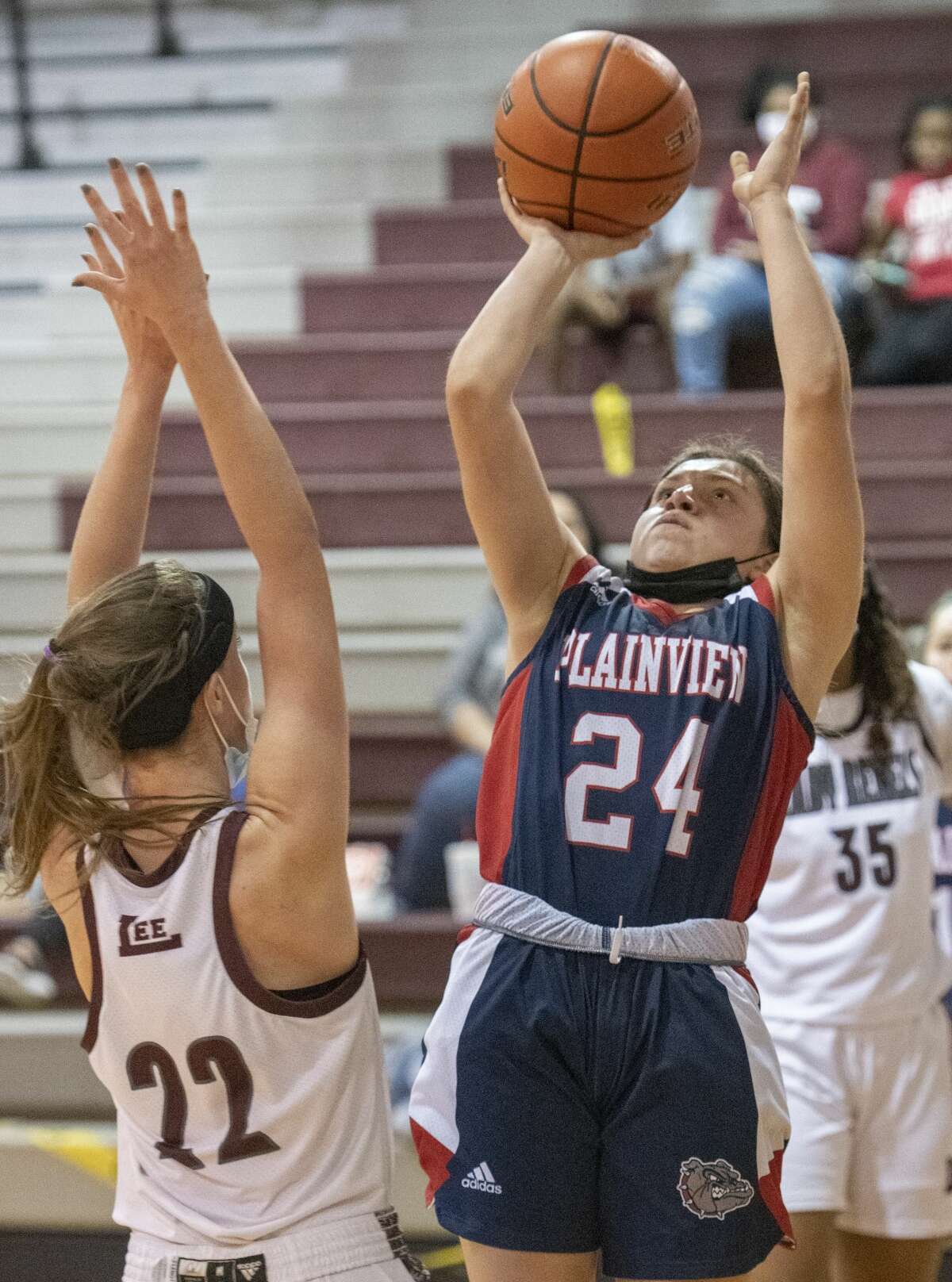 Plainview's Janessa Pauda pulls up for a shot as Lee High's Maggie Erdwurm defends 12/29/2020 at the Lee High gym. Tim Fischer/Reporter-Telegram