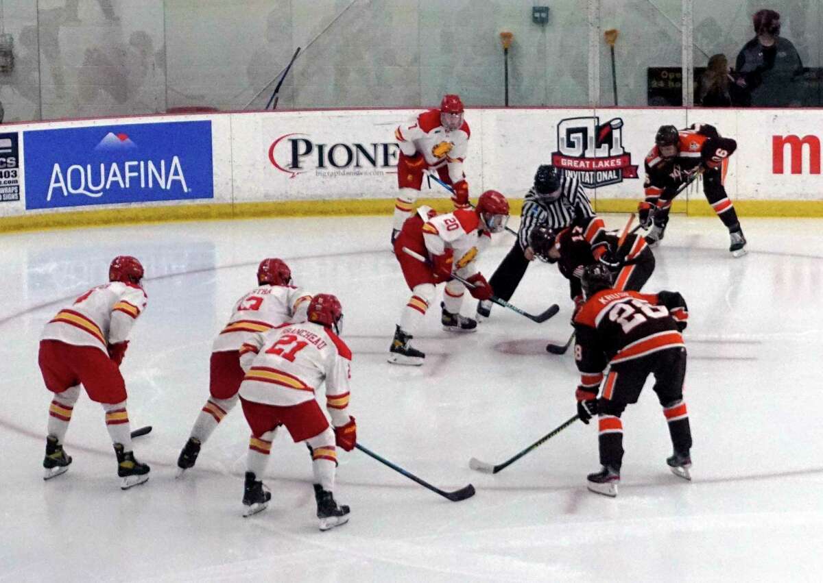 Members of Ferris State and Bowling Green's hockey team prepare for a faceoff during Sunday's game at Ewigleben Ice Arena. (Pioneer photo/Joe Judd)
