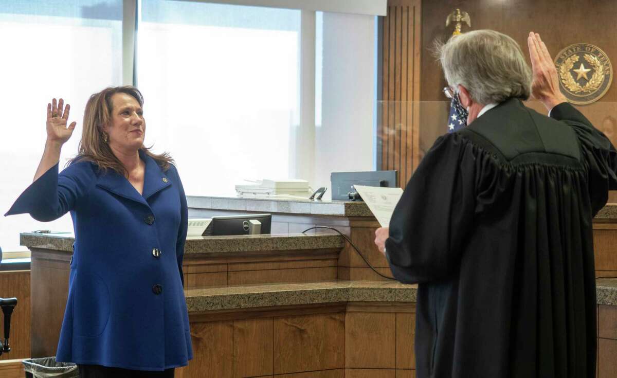 Midland County District Attorney Laura Nodolf take her oath of office from Judge Dean Rucker in 2021 in the Midland County 142nd District Courtroom. Tim Fischer/Reporter-Telegram