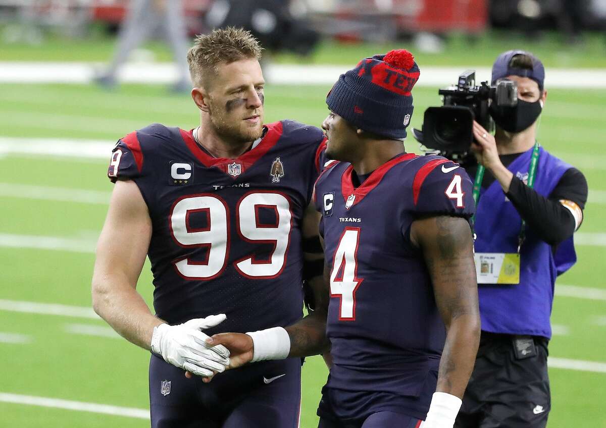 Houston Texans defensive end J.J. Watt (99) shakes hands with quarterback Deshaun Watson (4) walk back to the locker room after the Houston Texans 41-38 loss after the fourth quarter of an NFL football game Sunday, Jan. 3, 2021, at NRG Stadium in Houston .