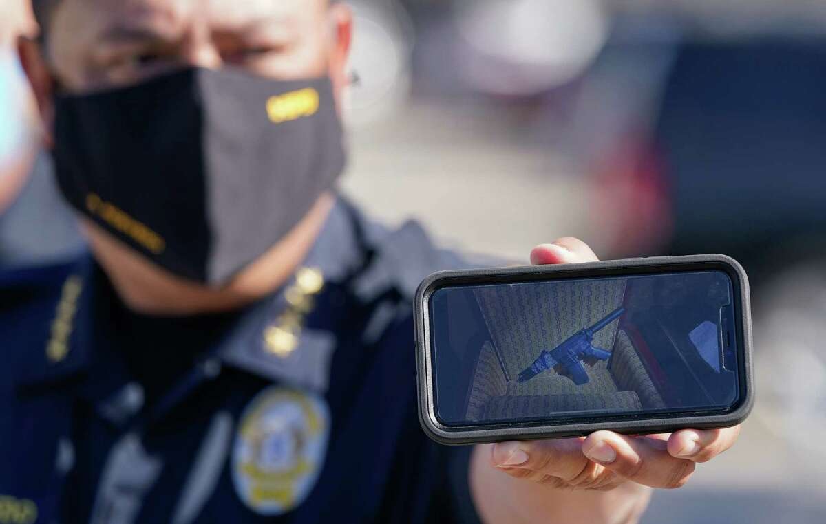 Houston Police Chief Art Acevedo holds a cell phone showing a photo of an assault rifle they found in a motel room used by one of suspects at the scene of an officer involved shooting at the North Villa Inn, 16510 North Freeway, Tuesday, Jan. 5, 2021 in Houston.