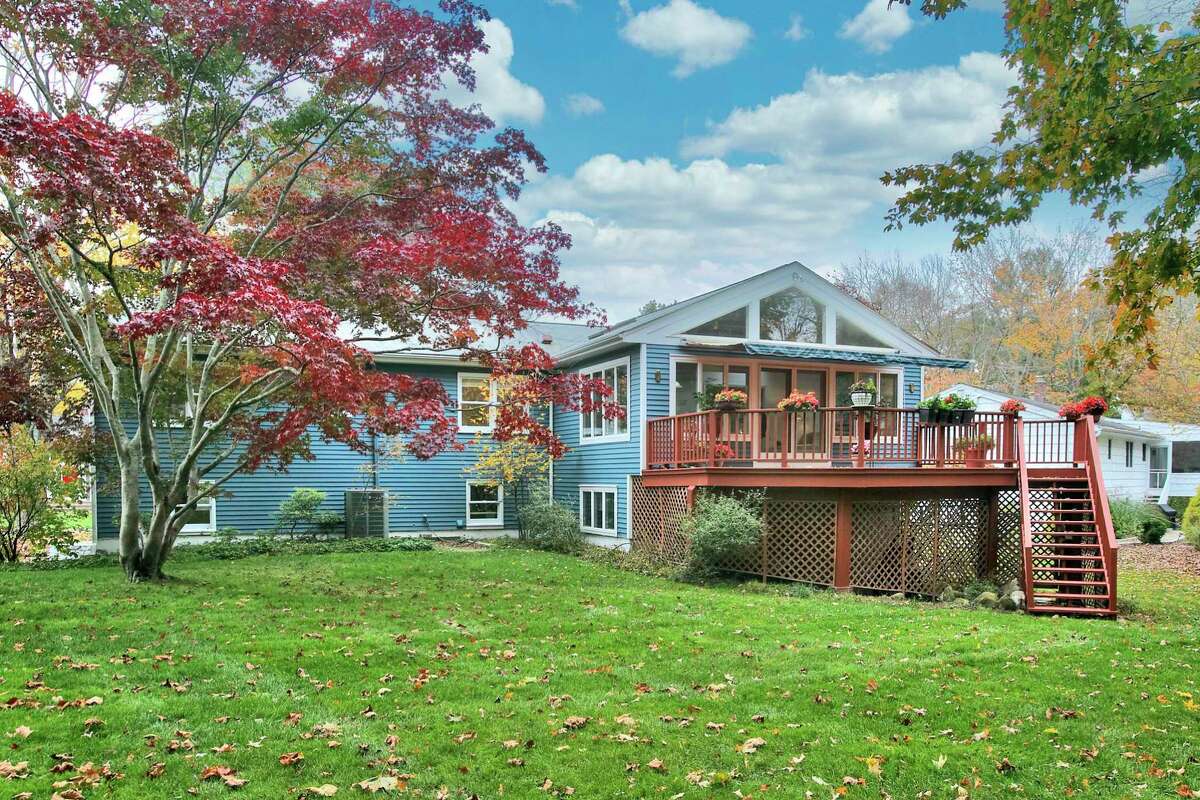The contemporary house at 6 Peaceful Lane, Westport sits on a level half acre property and features a raised deck. There’s a way to ensure a peaceful New Year and, in fact, a peaceful lifetime; by purchasing a house with the word indelibly tied to the address. The next owners of the midship blue-colored contemporary house at 6 Peaceful Lane in Westport can be assured of a more peaceful existence. Every time they have occasion to think of their address they may mentally take in and let out a calming breath. “This location truly embodies its name, ‘Peaceful Lane’ - with friendly, caring neighbors, no road or train noise impact, no through-traffic, just serenity with nearby conveniences,” according to the listing agent.