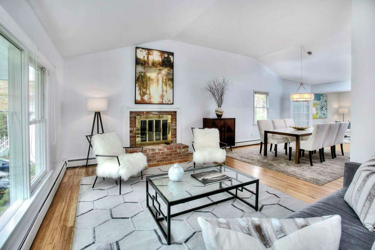 The living room has a fireplace and is open to the dining room at 6 Peaceful Lane, Westport. The 3,272-square-foot house sits on an in-town cul-de-sac, on a level lot of just over half an acre that is a short walk to the Post Road (Route 1), shops, dining establishments, Winslow Park and the Westport Country Playhouse. Westport’s Main Street is only a mile away; Longshore Club Park is about 2.5 miles away and Compo Beach just beyond that; and the Saugatuck Metro North Railroad train station is about three miles from this house.