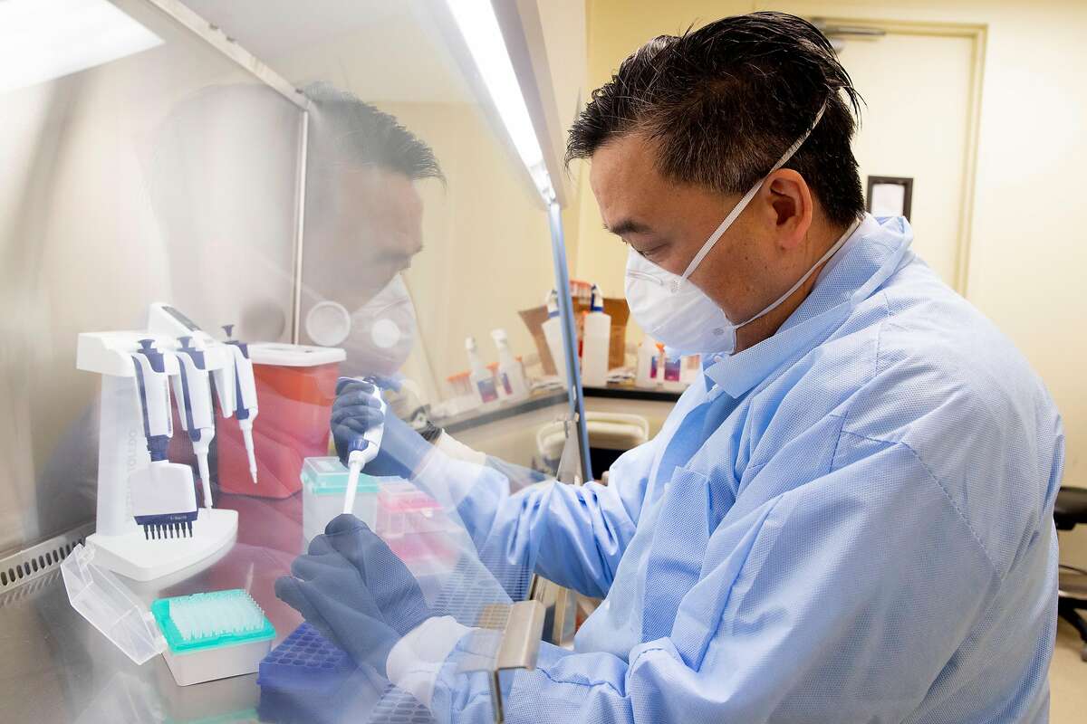UCSF-Abbott Viral Diagnostics and Discovery Center lab director Dr. Charles Chiu demonstrates the process of extracting samples of COVID-19 for sequencing while working in his lab in San Francisco, Calif. Tuesday, January 5, 2021. Public health experts are increasingly concerned about the impact of highly contagious coronavirus variants. UCSF is running tests on the strains of the virus circulating in California to help identify new strains.