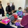 State Police Trooper Tamia Tucker prepares to receive the Moderna COVID-19 vaccine from Trumbull Public Health Nurse Samantha Cousins Tuesday Jan. 5 at the Center at Priscilla Place. The Health Department will hold a special clinic for school staff later this week.