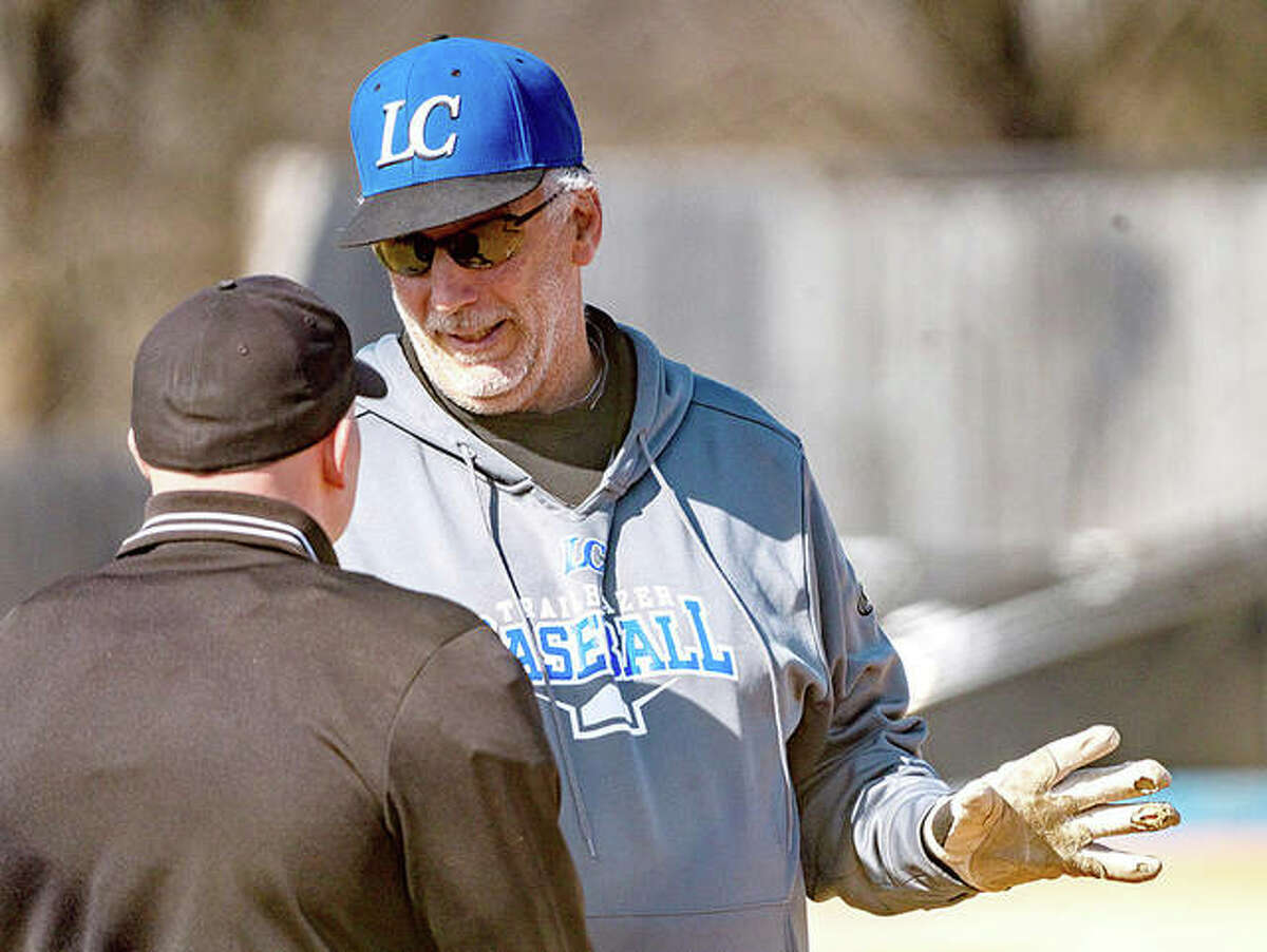 Lewis and Clark Community College baseball coach Randy Martz, right, talks with an umpire during a home game last March in Godfrey during a game against Kirkwood College.