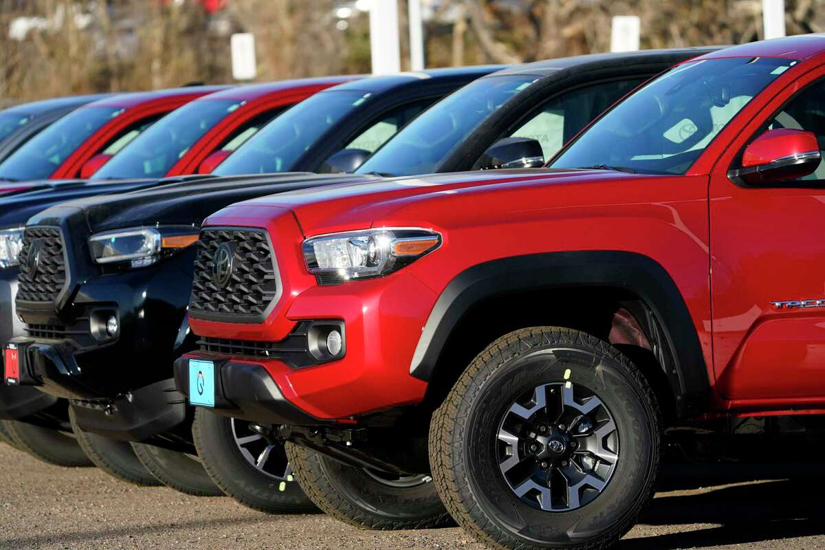 A long line of unsold 2021 Tacoma pickup trucks sits at a Toyota dealership Sunday, Nov. 8, 2020, in Englewood, Colo. The San Antonio-made Tacoma was one of Toyota’s top selling vehicles in 2020. (AP Photo/David Zalubowski)