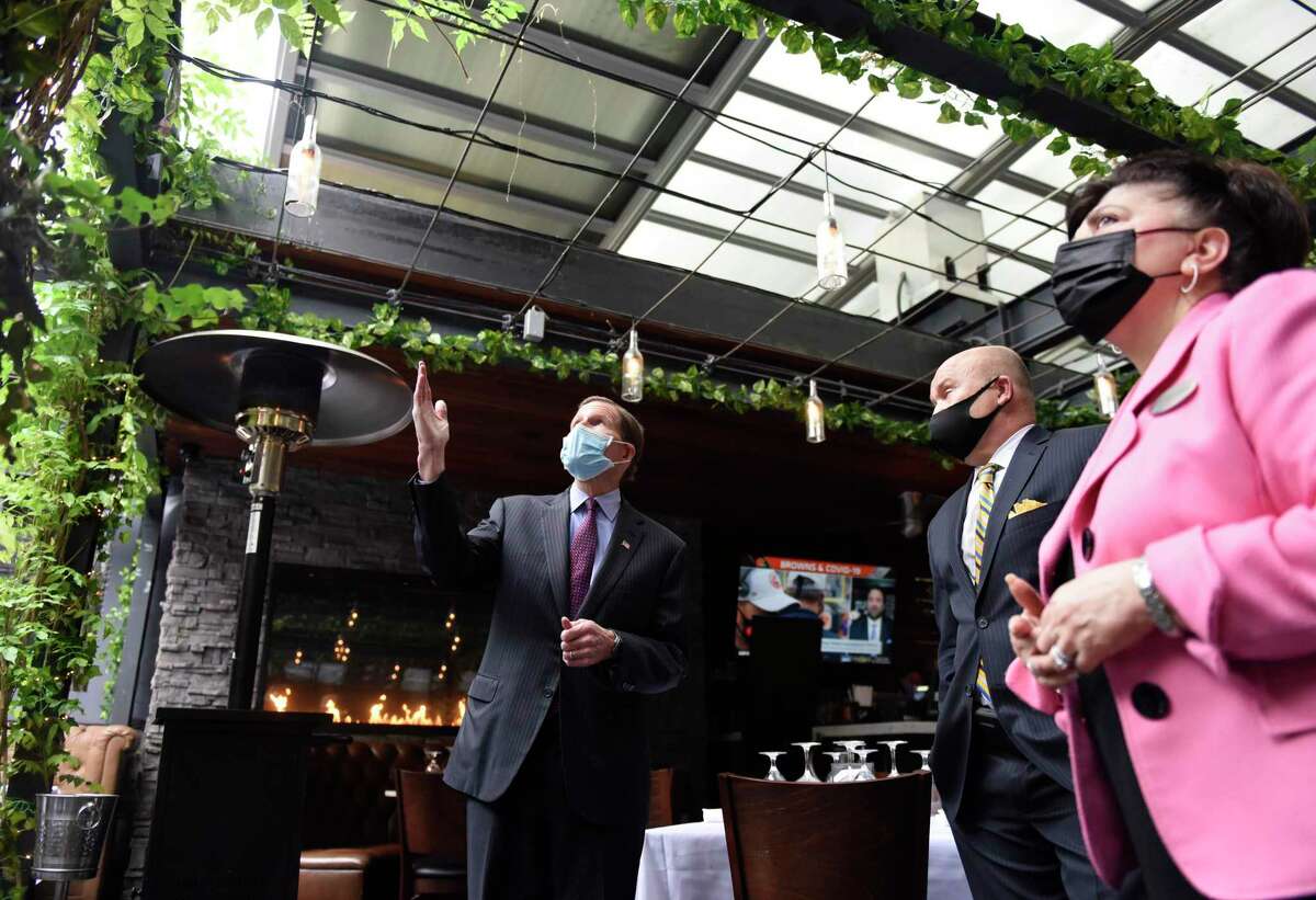 U.S. Sen. Richard Blumenthal, D-Conn., looks toward a retractable roof, an adaptation made to help business in the time of COVID-19, at Tony's at the J House while touring with J House General Manager Janice Perna-Nicholas and Tony's Managing Partner Tony Capasso in the Riverside section of Greenwich, Conn. Tuesday, Jan. 5, 2021. U.S. Sen. Blumenthal visited J House to discuss the economic impact of the coronavirus on local businesses and the impact of governmental assistance for small businesses.