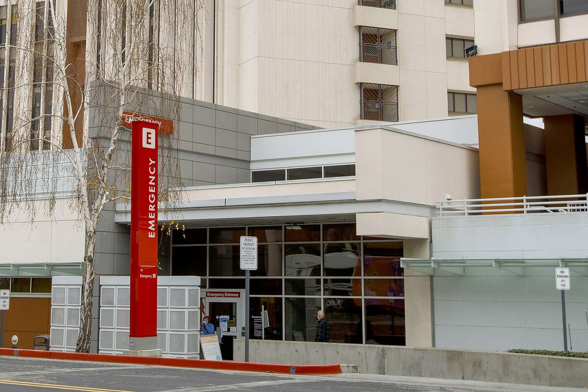 The emergency entrance at the Kaiser Permanente San Jose Medical Center is shown in San Jose, Calif., on Saturday, Jan. 2, 2021. A Kaiser Permanente employee is dead and dozens of workers have contracted the coronavirus after a staffer appeared at a Northern California medical center wearing an inflatable, air-powered holiday costume on Christmas Day, the hospital and health care company said Monday, Jan. 4, 2021. (Anda Chu/Bay Area News Group via AP)