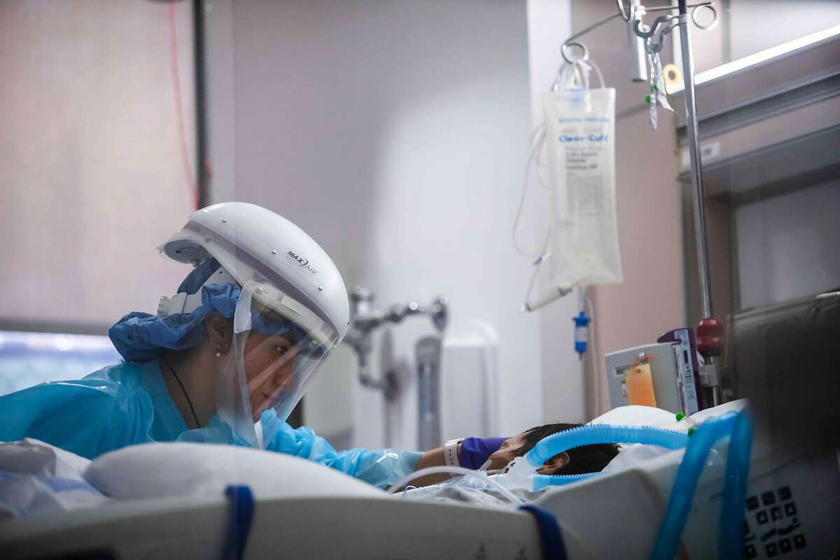Nurse Yeni Sandoval wears personal protective equipment while caring for a COVID-19 patient at Providence Cedars-Sinai Tarzana Medical Center.