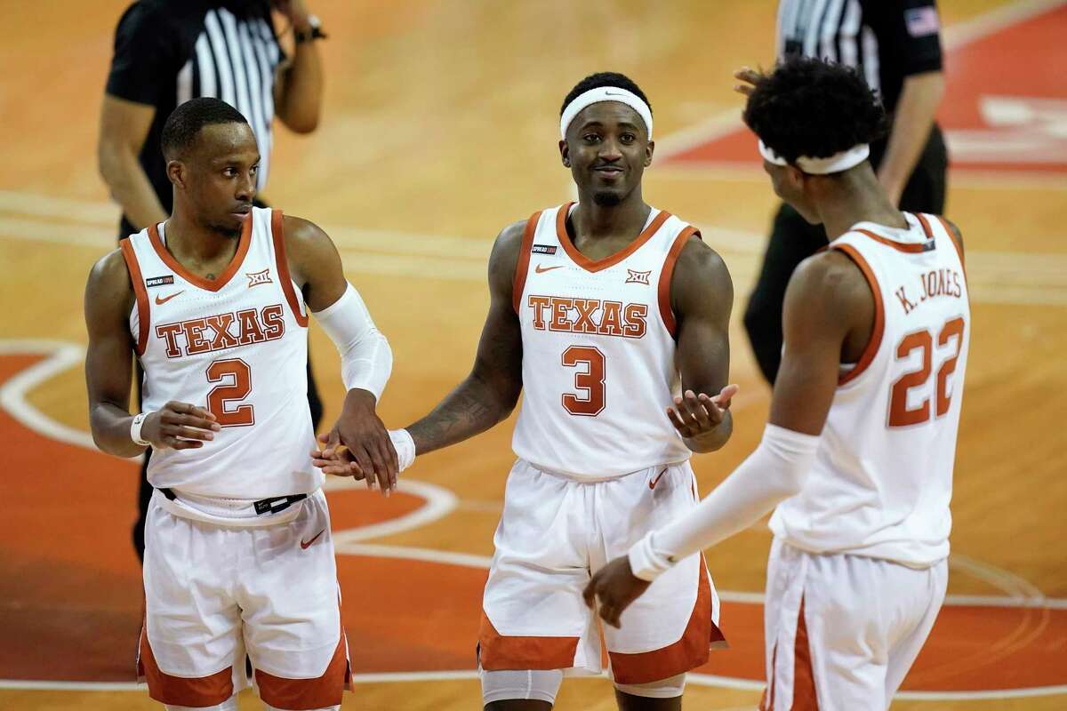UT’s Courtney Ramey, center, celebrates with Matt Coleman III, left, and Kai Jones after the victory pushed the Horns to 9-1 (3-0 Big 12).