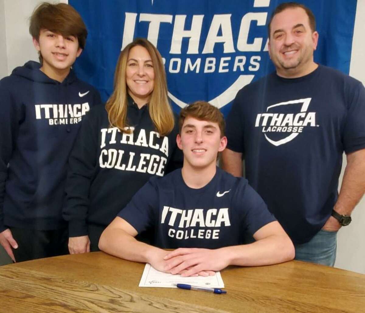 Shelton’s Jared Sedlock is joined by brother Logan. mom Tracey and dad Drew when he officially chose to play lacrosse at Ithaca College.