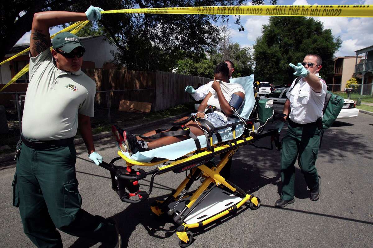 Ambulance workers transport a woman on a gurney in August 2010. An argument in the neighborhood turned into a melee with shots fired and fights breaking out, injuring several people. A new customized app provided by the 100 Club of San Antonio to all first responders in Bexar County will allow them to seek help for handling personal issues — everything from parenting and finances to handling alcohol abuse and the effects of trauma — anonymously.