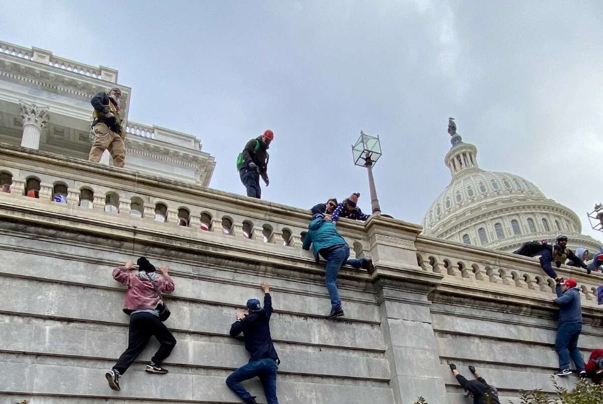 Dramatic Photo Shows Trump Supporters Scaling Capitol Wall