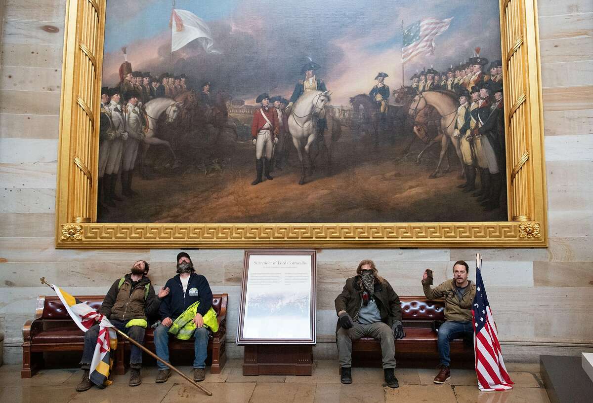 Supporters of President Donald Trump sit in the US Capitol Rotunda on January 6, 2021, in Washington, DC.