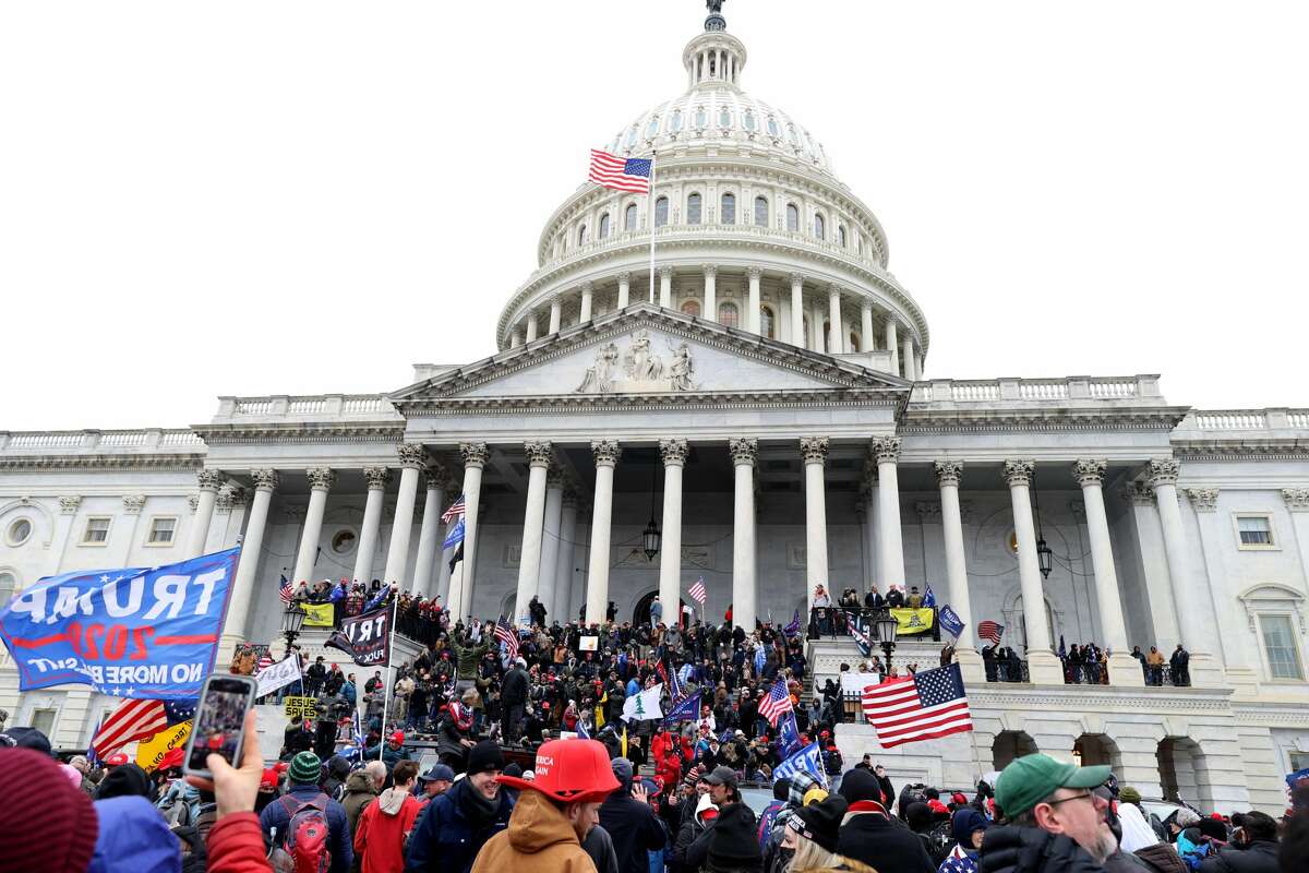 WASHINGTON, DC - JANUARY 06: Protesters gather on the U.S. Capitol Building on January 06, 2021 in Washington, DC. Pro-Trump protesters entered the U.S. Capitol building after mass demonstrations in the nation's capital during a joint session Congress to ratify President-elect Joe Biden's 306-232 Electoral College win over President Donald Trump. (Photo by Tasos Katopodis/Getty Images)