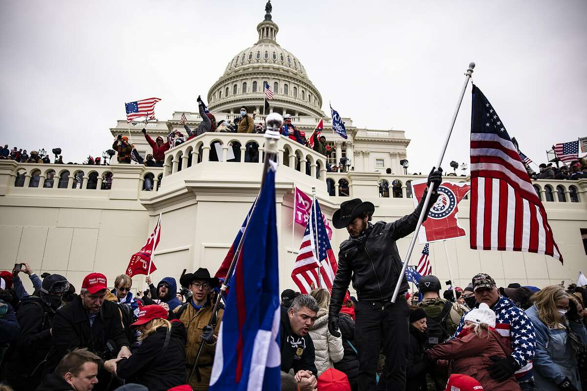 Pro-Trump supporters storm the U.S. Capitol following a rally with <a class=